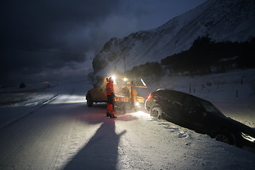 Image showing Car being towed after accident in snow storm