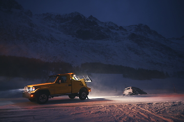 Image showing Car being towed after accident in snow storm