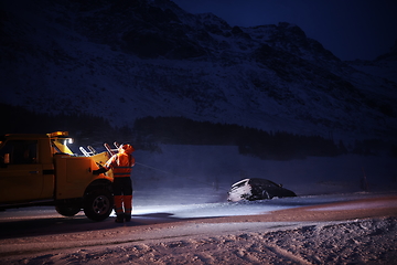 Image showing Car being towed after accident in snow storm