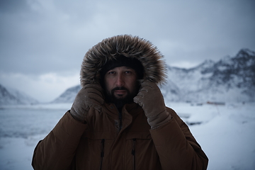 Image showing man at winter in stormy weather wearing warm fur jacket