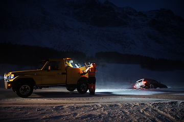 Image showing Car being towed after accident in snow storm