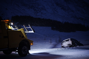 Image showing Car being towed after accident in snow storm