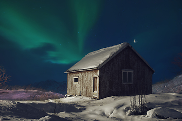 Image showing Aurora borealis Green northern lights above mountains