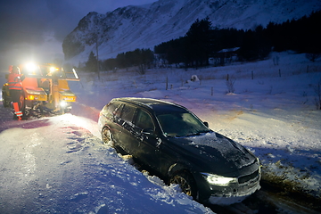 Image showing Car being towed after accident in snow storm