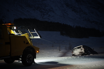 Image showing Car being towed after accident in snow storm