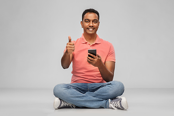 Image showing happy indian man with smartphone showing thumbs up