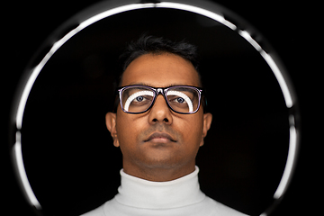 Image showing man in glasses with white illumination over black