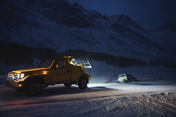 Image showing Car being towed after accident in snow storm