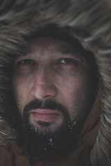 Image showing man at winter in stormy weather wearing warm fur jacket