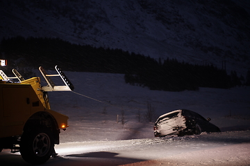 Image showing Car being towed after accident in snow storm