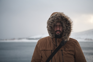 Image showing man at winter in stormy weather wearing warm fur jacket