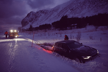 Image showing Car being towed after accident in snow storm