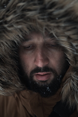 Image showing man at winter in stormy weather wearing warm fur jacket