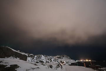 Image showing Aurora borealis Green northern lights above mountains