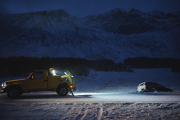 Image showing Car being towed after accident in snow storm