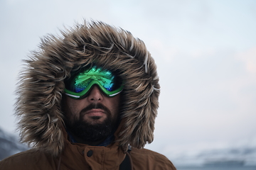 Image showing man at winter in stormy weather wearing warm fur jacket