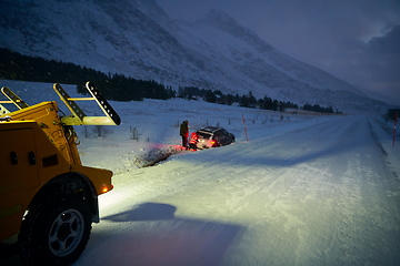 Image showing Car being towed after accident in snow storm