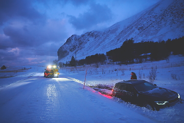 Image showing Car being towed after accident in snow storm