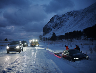 Image showing Car being towed after accident in snow storm