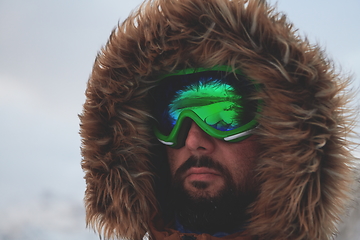 Image showing man at winter in stormy weather wearing warm fur jacket