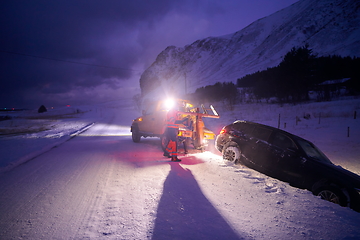 Image showing Car being towed after accident in snow storm