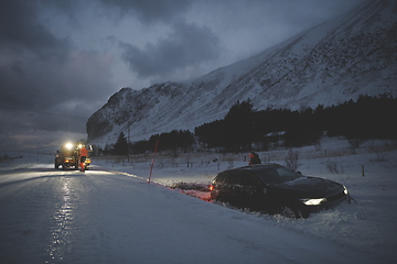 Image showing Car being towed after accident in snow storm