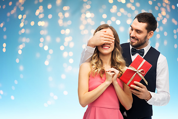 Image showing happy man giving woman surprise present