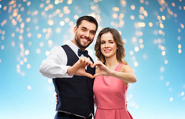 Image showing happy couple making hand heart on valentines day