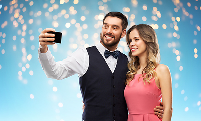 Image showing happy couple taking selfie by smartphone