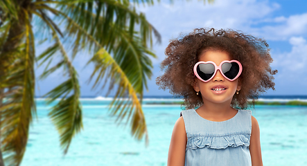 Image showing little african girl in sunglasses on beach