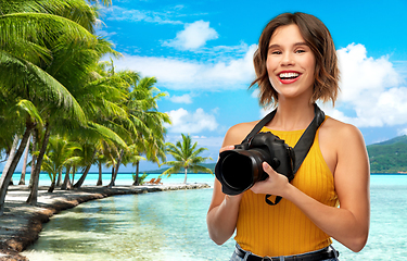 Image showing happy woman photographer with camera on beach
