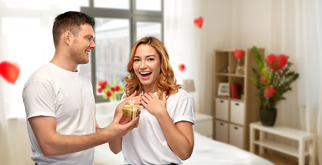 Image showing happy couple with gift at home