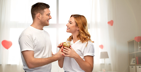 Image showing happy couple with gift on valentines day at home