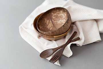 Image showing close up of coconut bowl, wooden spoon and fork