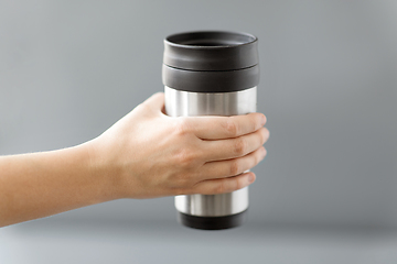 Image showing hand holding tumbler mug or thermo cup