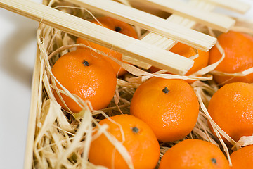 Image showing tangerines with straw