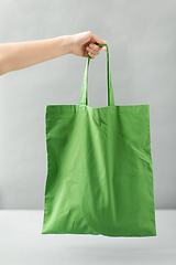 Image showing hand holding reusable canvas bag for food shopping