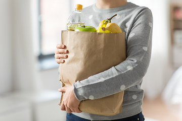 Image showing close up of woman with paper bag full of food