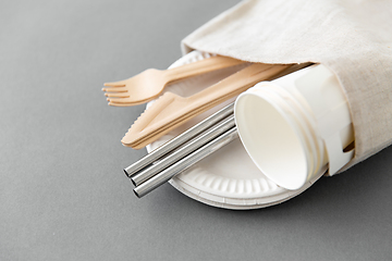 Image showing wooden forks, knives and paper cups on plate