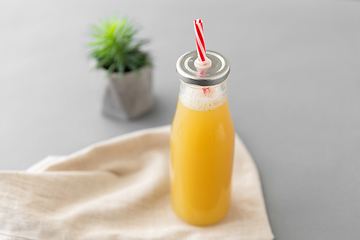 Image showing reusable glass bottle of fruit juice with straw