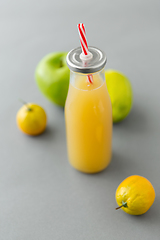 Image showing reusable glass bottle of fruit juice with straw