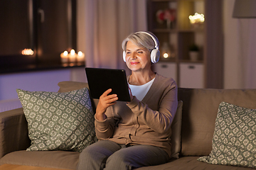 Image showing senior woman in headphones listening to music