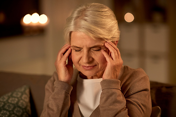 Image showing unhappy senior woman suffering from headache