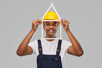 Image showing happy indian builder with ruler in shape of home