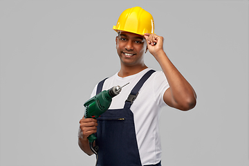 Image showing happy indian builder in helmet with electric drill