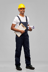 Image showing happy indian builder with blueprint and clipboard