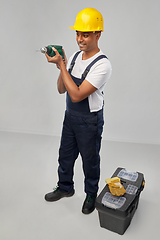 Image showing happy indian builder in helmet with electric drill