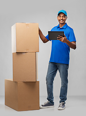 Image showing indian delivery man with tablet pc and boxes