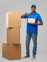 Image showing indian delivery man with tablet pc and boxes