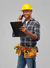 Image showing indian builder in helmet calling on smartphone